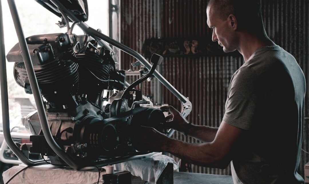Mechanic working on a motorcycle engine and suspension assembly